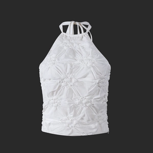 Detail of white halter neck top featuring elegant 3D textured pleated floral fabric