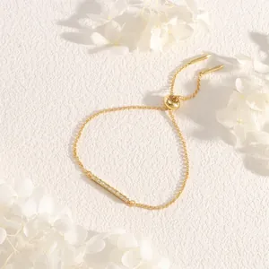 Close-up of adjustable gold box chain bracelet with sparkling zircon bar inlay