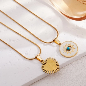 Vintage gold Turkish Eye necklace with snake chains on white decorative steps