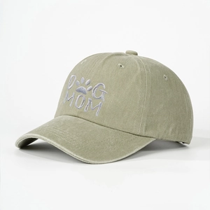 Detailed close-up of the DOG MOM embroidery on washed olive green cotton baseball cap