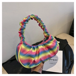 Detail of colorful rainbow pleated shoulder bag with satin texture and vibrant color gradient