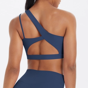 Detail of navy blue one-shoulder sports bra with asymmetrical back cutout and elastic straps