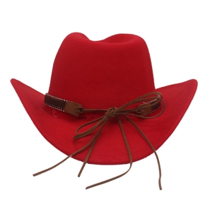 Detail of red wool felt cowboy hat with leather band and decorative western bow