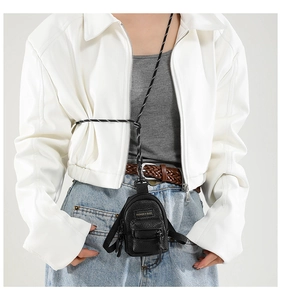 Miniature black pebble leather crossbody bag for girls showing compact size and woven strap