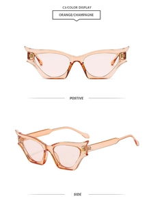 Detail view of orange cat-eye sunglasses with transparent frames and gold accents