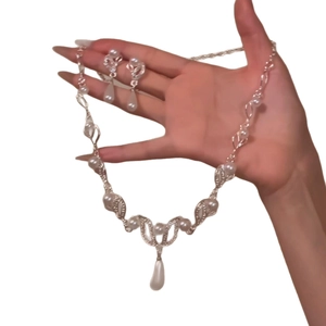 Elegant silver leaf jewelry set with white teardrop pearls and pavé diamonds for women