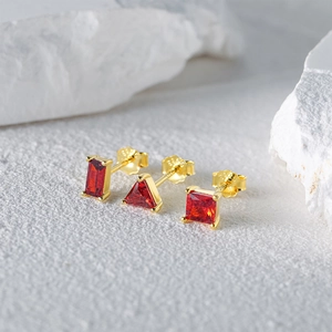Close-up of S925 hallmark on gold plated geometric earrings with red stones