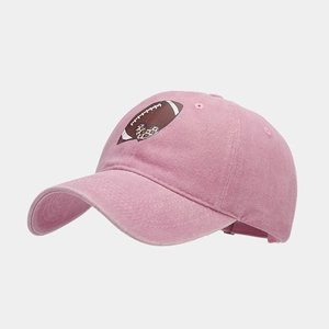 Detailed macro view of pink washed cotton fabric and heart football print on baseball cap