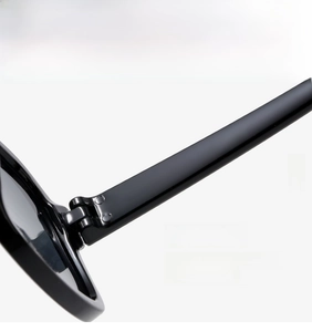 Detail of durable metal hinges on classic black square sunglasses for smooth opening