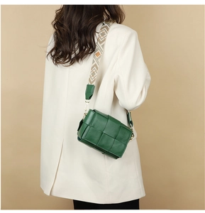 Detailed back view of green woven leather crossbody bag with geometric wide shoulder strap
