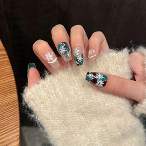 Hand-painted Christmas snowflake press-on nails with red and green winter art design