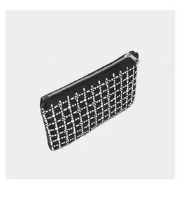 Detailed view of black rhinestone handbag with silver metal zipper and crystal grid patterns