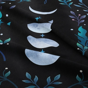 Bohemian moon phase tapestry with stars and teal botanical leaves on black fabric
