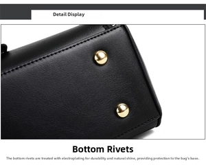 Close-up of black pebble leather handbag base with gold protective metal feet rivets