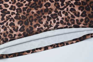 Detail of leopard print fabric with high-density knit texture and double-stitch seam edge