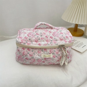Pink floral quilted makeup bag featuring a soft top handle and Scrabble logo plaque