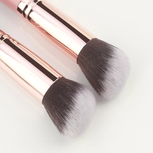 Close-up of angled foundation brushes with rose gold ferrule and dual-tone soft bristles