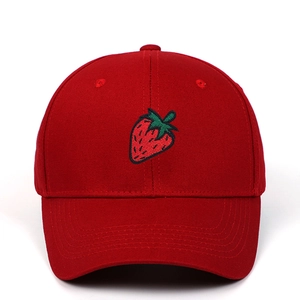 Close-up of vibrant red baseball cap featuring detailed strawberry embroidery on front