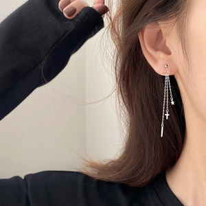 Silver cross and star tassel chain earrings shown on model for a stylish look