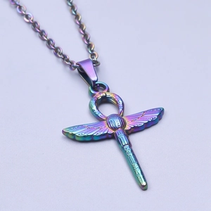 Macro view of a colorful rainbow dragonfly Ankh cross pendant made of stainless steel