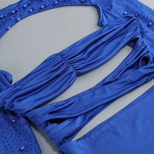 Detailed macro view of royal blue cocktail dress with rhinestones and pleated texture