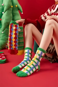 Detail of soft coral fleece Christmas socks featuring festive patterns and vibrant colors