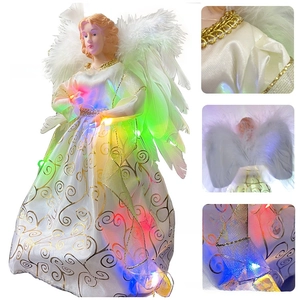 Close-up of LED glowing angel tree topper with gold patterns and white feather wings
