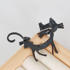 Black enamel cat brooch with long pin closure back view in sleek metal alloy plating