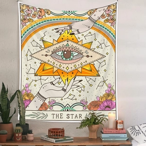 Close-up of The Star Tarot tapestry hanging in a cozy bohemian interior setting