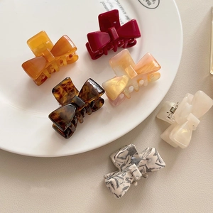 Set of 6 colorful acetate bow hair claws in tortoiseshell and marble patterns