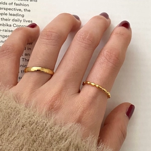 Stacked 925 sterling silver olive bead and smooth wide rings in gold finish