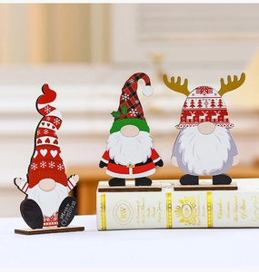 Three wooden Christmas gnomes figurines with festive patterns on a book for home decor