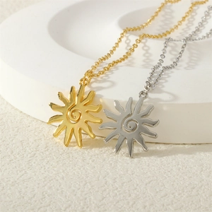 Elegant gold and silver sun pendant necklaces with spiral texture on stone display