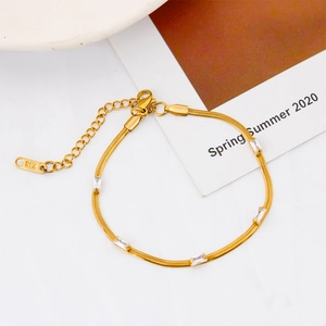 Close-up of 18K gold plated snake chain bracelet with five rectangular zircons and K18 tag