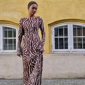 Detail of long sleeve zebra print dress showing the textured fabric and leopard pattern