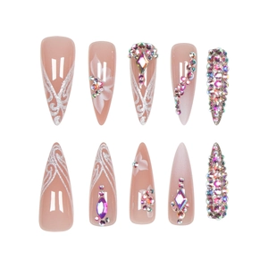 Nude pink stiletto press-on nails with silver glitter lines and luxury crystals