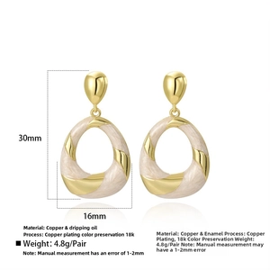 Detailed view of oval enamel drop earrings with gold plating and measurement specs