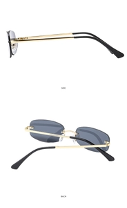 Detail view of rimless retro sunglasses with dark grey lenses and gold metal temples