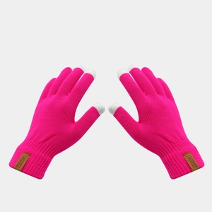 Detail of rose red knitted touch screen gloves with grey fingertips and leather logo tag