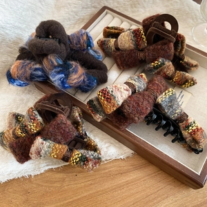 Detail shot of vintage flocking bow hair claw clips with various wool fabric textures