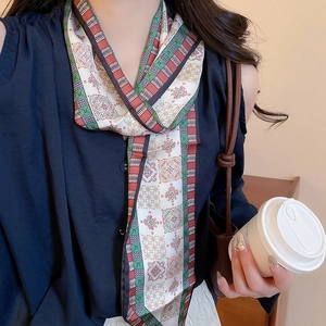 Detail showing paisley print scarf necklace tied around the neck in French retro style