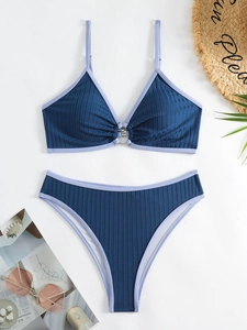 Deep blue ribbed bikini set with metal ring detail and high-cut bottoms for beach vacations
