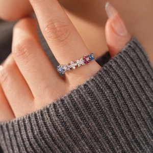 Close-up of 18k gold plated ring with colorful zircon floral cluster on a model hand