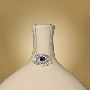 Detail of S925 sterling silver evil eye pendant with blue gemstones and star charm