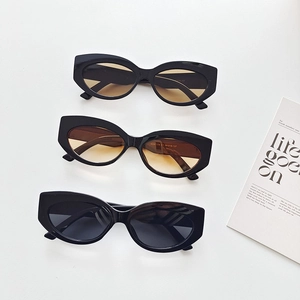 Three pairs of vintage cat-eye sunglasses with grey, yellow, and gradient tea-colored lenses