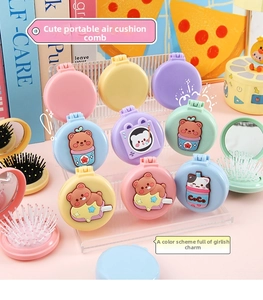 Close-up of portable cartoon folding hairbrush with integrated vanity mirror for girls