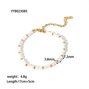 Macro shot of bamboo-shaped shell beads with dimensions 3.8x7.2mm on gold chain