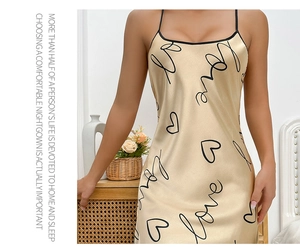 Detail of champagne satin nightgown featuring black love lettering and delicate straps