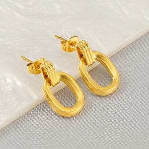 Detailed close-up of gold stainless steel oval stud earrings with brushed matte finish texture