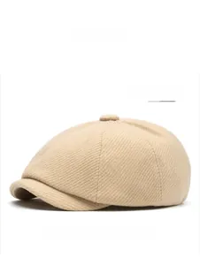 Detailed view of the beige wool-blend newsboy cap showing twill weaving texture